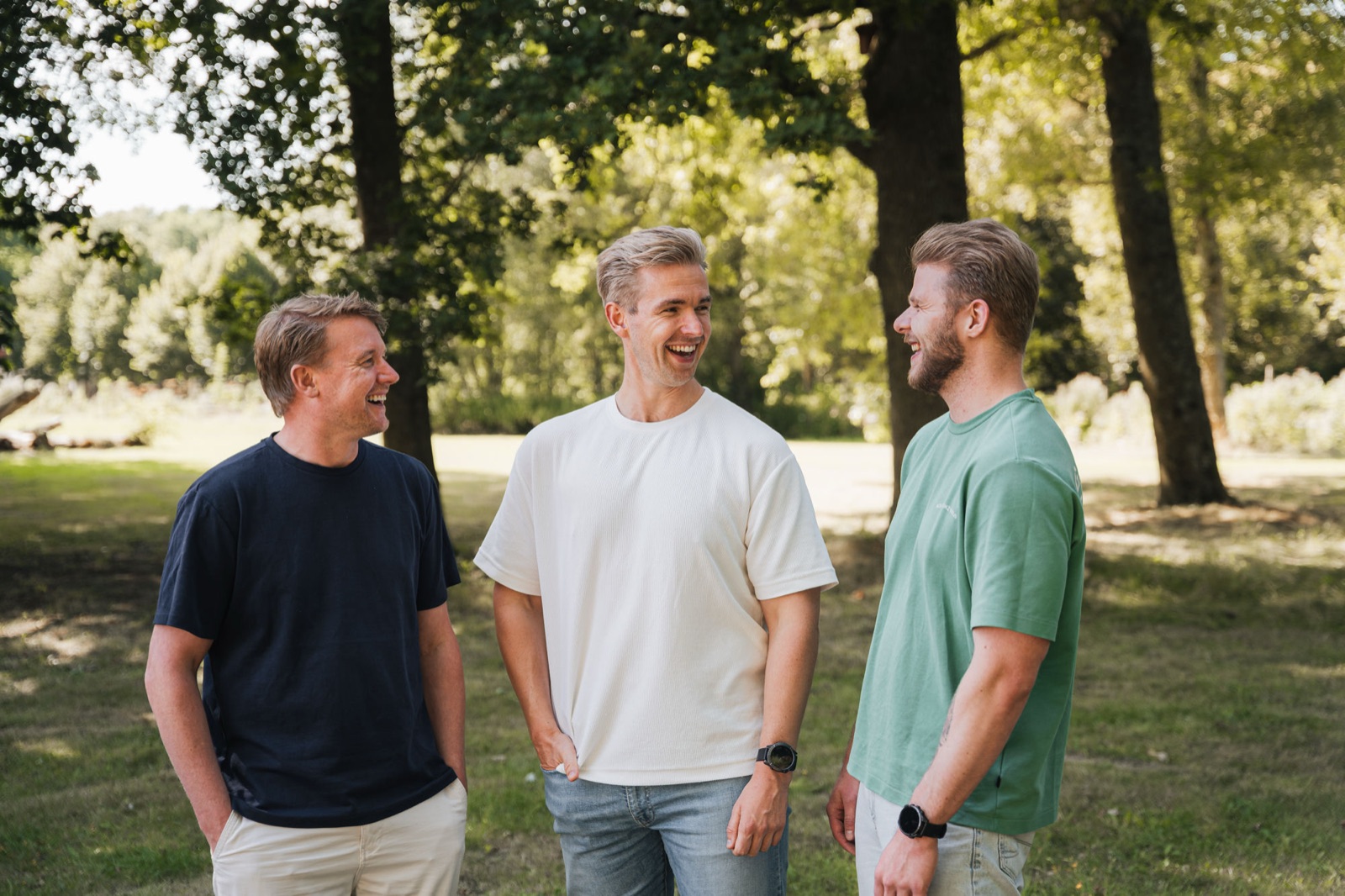 Het team van Empathree lacht samen buiten in het park